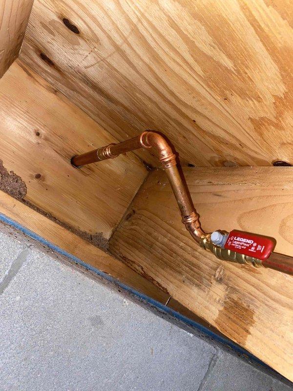 Completed outdoor spigot replacement on 36-year-old residential property. Removed deteriorated existing hose bib showing significant corrosion and oxidation, then installed new copper piping with shutoff valve in crawlspace area. Secured copper lines between floor joists using proper supports and connected new frost-free sillcock through exterior wall penetration above brick foundation. Tested system for proper operation and verified no leaks at connections. Old corroded fixture removed and disposed of properly.