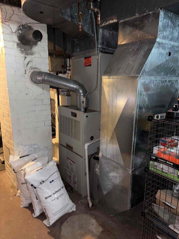 Conducted comprehensive assessment of existing residential HVAC system in basement utility area for equipment replacement estimate. Evaluated current furnace unit and associated air conditioning components, including inspection of ductwork configuration, plenum assembly, and overall system layout. Documented existing equipment conditions, including furnace age and operational status of AC system, to provide accurate replacement recommendations. Assessed outdoor condenser location and clearance requirements for future installation planning. Customer inquiry received through Kobella referral, with financing options discussed for proposed system replacement at 0% interest over 36-month term.