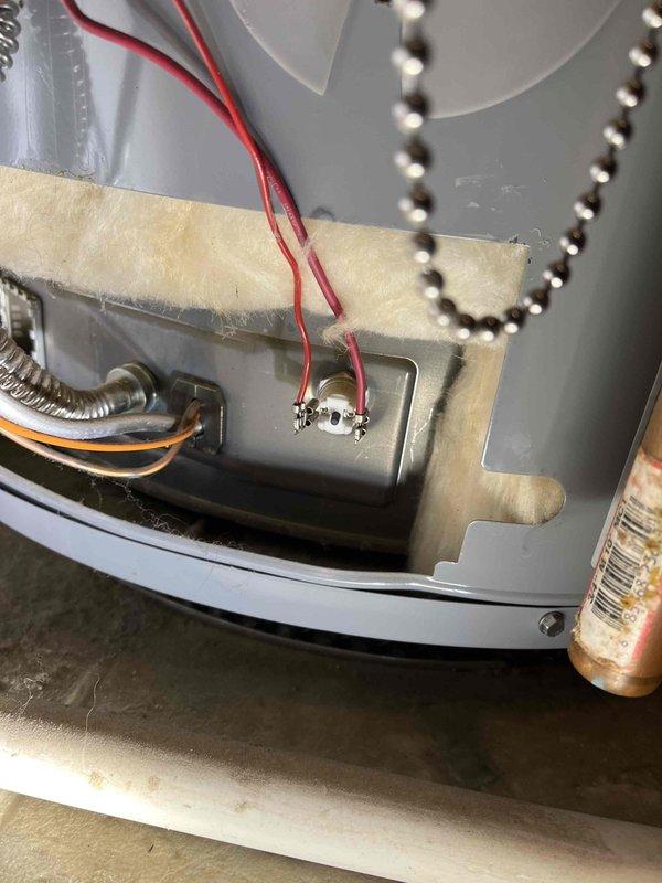 Responded to no hot water complaint in 30-year-old home with one-year-old water heater. Upon inspection, discovered significant lint and debris accumulation affecting the unit's combustion air intake and blower assembly. Removed and cleaned accumulated lint from blower housing and filter tray, inspected electrical connections and wiring, and verified proper operation of heating elements and thermostat controls. Restored hot water service to entire home after clearing obstructions and confirming unit functionality.