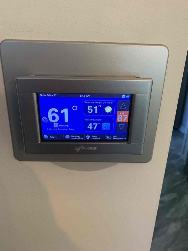 Responded to service call for Trane thermostat displaying partial screen malfunction on left side following storm-related internet outage. Upon arrival, inspected thermostat and confirmed display was functioning properly, showing current temperature of 61°F, outdoor temperature, humidity levels, and all menu options clearly visible on touchscreen. Verified thermostat communication and system status, finding unit operational with no further issues present at time of inspection.
