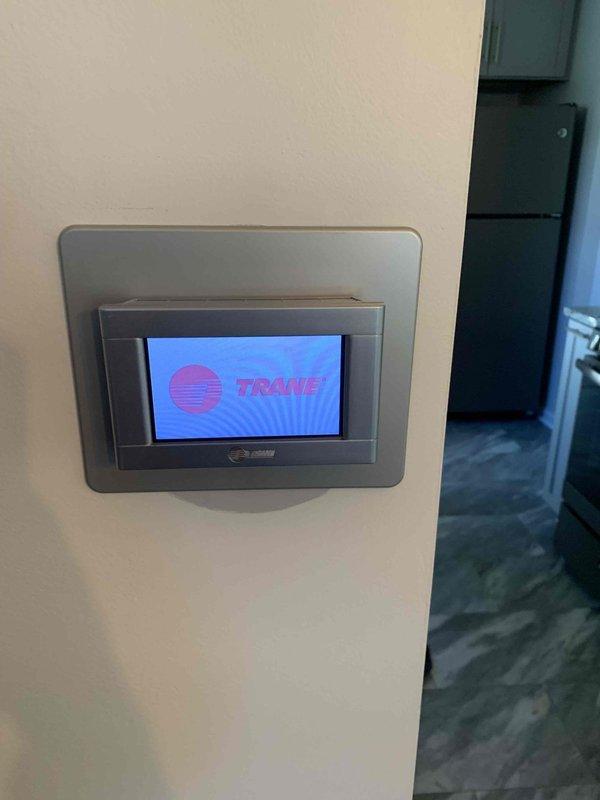 Responded to service call for Trane thermostat displaying partial screen malfunction on left side following storm-related internet outage. Upon arrival, inspected thermostat and confirmed display was functioning properly, showing current temperature of 61°F, outdoor temperature, humidity levels, and all menu options clearly visible on touchscreen. Verified thermostat communication and system status, finding unit operational with no further issues present at time of inspection.