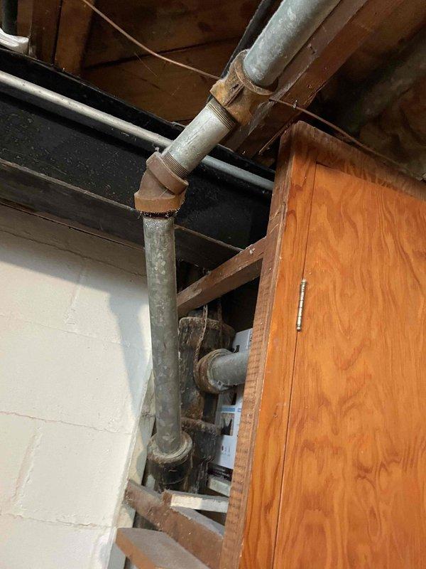 Responded to service call for slow draining bathtub with suspected clog in basement drainage system. Upon inspection, identified severely corroded cast iron drain pipes in basement with extensive rust deterioration and surface degradation affecting drainage performance. Documented existing plumbing infrastructure showing aging metal pipes with heavy oxidation at joints and connections. Provided assessment and quote for replacement of deteriorated cast iron drainage piping with PVC pipe system to restore proper drainage function and eliminate slow drain issue.