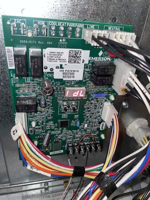 Responded to no-cooling complaint on residential HVAC system installed two years ago. Upon arrival, confirmed no airflow from supply vents and indoor temperature reading 76°F with thermostat set to 70°F. Diagnosed control board failure indicated by "dL" error code displayed on Emerson circuit board LED. Replaced defective control board (part number 59M47-096-01) and verified all wire connections to terminals. Inspected evaporator coil and found heavy dust and debris accumulation on fins restricting airflow. Performed thorough coil cleaning to restore proper heat exchange efficiency. Cycled system through complete operational test, confirmed proper cooling cycle engagement, verified adequate airflow at all registers, and ensured thermostat communication with new control board. System restored to full functionality.