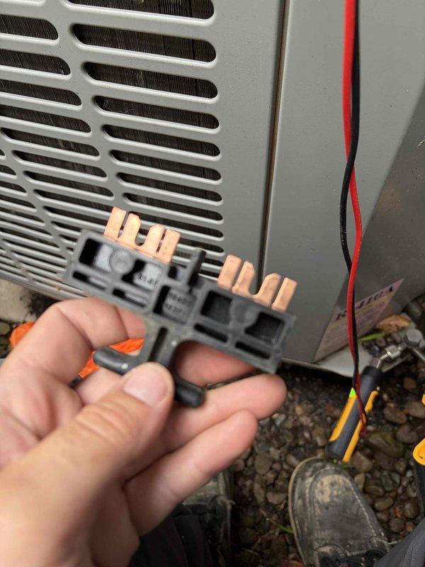 Responded to service call for 15-year-old air conditioning system reported as not cooling and never operating efficiently. Performed diagnostic testing using electrical meter to measure voltage and amperage at the outdoor condensing unit, recording 237.7 volts at the equipment. Inspected and tested the compressor contactor and electrical connections, removing and examining the three-pole contactor assembly for signs of wear, pitting, or failure. Evaluated the condition of the condenser coil fins and overall system components to determine the cause of cooling failure and poor historical performance.