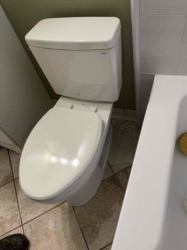 Completed toilet replacement in residential bathroom. Removed existing two-piece toilet fixture and installed new unit per customer request. Protected surrounding floor area with plastic sheeting during installation to prevent damage to wood-look plank flooring. Ensured proper sealing, secure mounting, and verified flush mechanism operation upon completion.