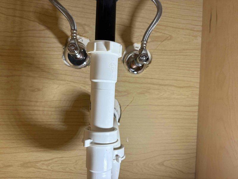 Responded to service call for bathroom sink pop-up drain assembly that was stuck in the closed position. Upon arrival, found that the pop-up stopper mechanism had become jammed after customer attempted to free it themselves. Disassembled the drain linkage assembly beneath the sink, removed the pivot rod and clevis connection, and extracted the stuck pop-up stopper from the drain body. Inspected all components for wear and damage, cleaned debris from the drain assembly, and reinstalled the pop-up mechanism with proper alignment. Tested the stopper operation multiple times to ensure smooth up and down movement, verified proper seal when closed, and confirmed drain flow when open. System restored to full functionality.