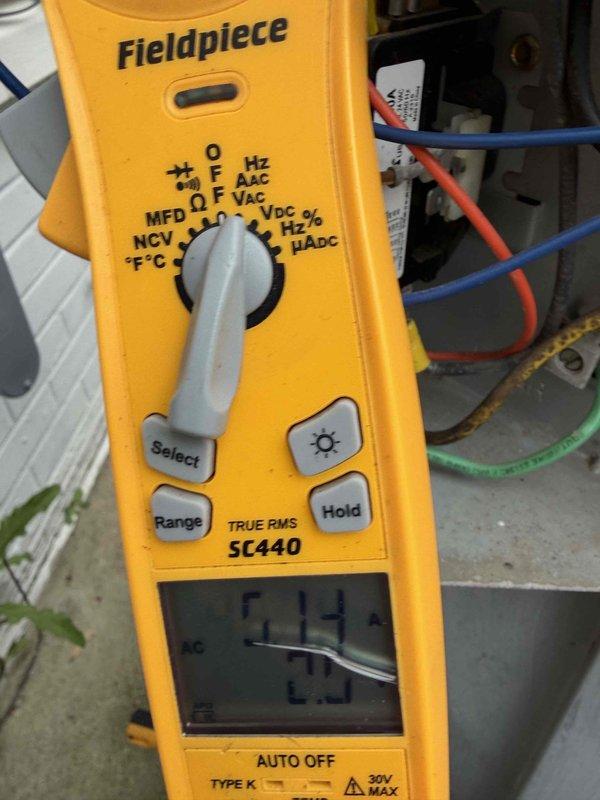 # HVAC Service Completed

Responded to service call for 16-year-old Carrier air conditioning system experiencing no cooling output and electrical flickering during operation. Upon arrival, performed diagnostic assessment of indoor air handler unit located in utility room.

Conducted electrical testing using digital multimeter to measure voltage and amperage at unit connections. Observed abnormal electrical readings consistent with reported flickering issue. Inspected all electrical connections, wiring terminals, and circuit components for signs of arcing, overheating, or loose connections that could cause voltage fluctuations.

Evaluated compressor operation and capacitor function to determine cause of no cooling condition. Checked refrigerant lines, condensate drain system with multiple PVC drain lines, and overall system integrity. Documented equipment condition through photographic evidence showing unit configuration, piping arrangement, and electrical testing procedures.

System re