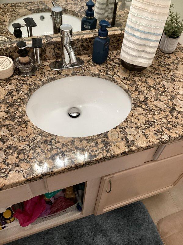 Completed club membership renewal and plumbing maintenance visit. Addressed slow drainage issues in both kitchen and bathroom sinks. Inspected bathroom vanity with undermount sink and chrome pop-up drain assembly, along with water heating system components including expansion tank and copper supply lines. All plumbing fixtures and connections evaluated for proper operation and drainage performance.
