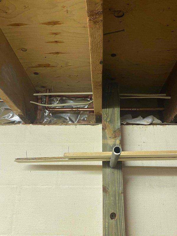 Completed installation of K84 Twin-Flo hot water coil with fan assist unit beneath new sink location in crawl space area. Modified existing fin tube baseboard heating system by shortening 7-foot section to 5 feet in dining room to accommodate room layout changes.