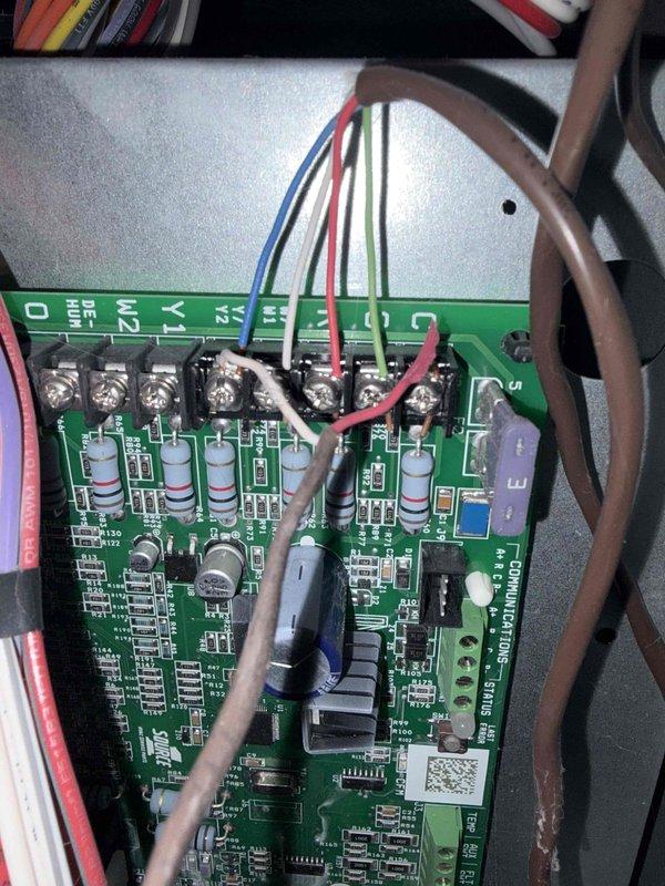 Responded to no heat/no cool condition on previously installed HVAC system. Upon inspection, discovered failed control board and blown fuses in outdoor disconnect. Documented existing circuit board showing multiple compromised electronic components and capacitors. Removed and inspected outdoor fuse block assembly, confirming both fuses had failed. Replaced defective control board and fuses to restore system operation for both heating and cooling modes.