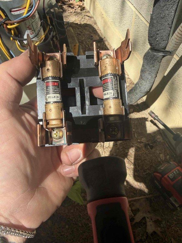 Responded to no heat/no cool condition on previously installed HVAC system. Upon inspection, discovered failed control board and blown fuses in outdoor disconnect. Documented existing circuit board showing multiple compromised electronic components and capacitors. Removed and inspected outdoor fuse block assembly, confirming both fuses had failed. Replaced defective control board and fuses to restore system operation for both heating and cooling modes.