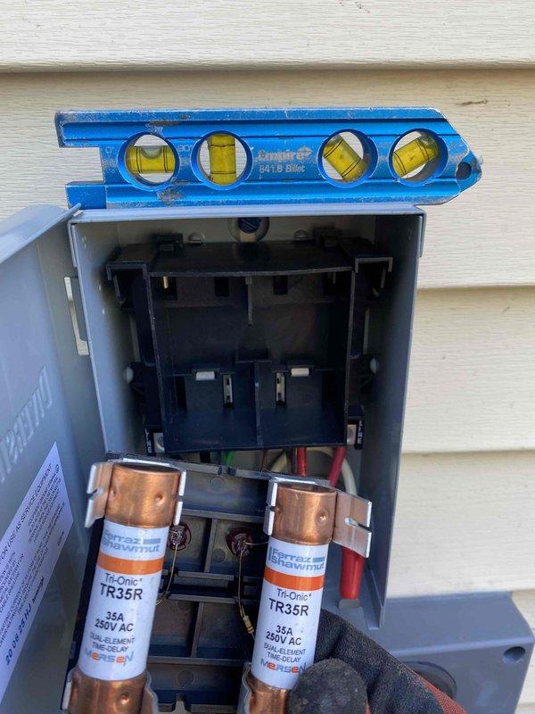 Completed full HVAC system installation including outdoor condensing unit and associated electrical components. Installed 35-amp fused disconnect box with Ferraz Shawmut TR35R fuses rated at 250V AC, mounted on exterior wall with proper leveling verification. Connected all electrical wiring to code specifications including power supply lines and control circuits. Performed refrigerant evacuation and charging procedures, utilizing digital vacuum gauge to verify system achieved proper vacuum levels of 32 microns before charging. Connected copper refrigerant lines between indoor and outdoor units with proper insulation and securing. System tested and confirmed operational with all safety controls functioning as designed.