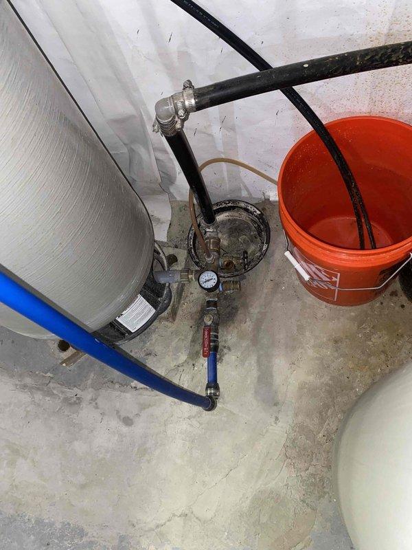 Returned to property to complete installation of pressure reducing valve (PRV) that was previously sold. Installed brass PRV assembly on main water supply line with appropriate compression fittings and connections. Mounted unit on existing red panel near water treatment system. Verified proper orientation and secure mounting of pressure regulator. Connected inlet and outlet piping using brass fittings to ensure leak-free operation. Tested system operation and confirmed pressure regulation functioning correctly. Left installation instructions posted on panel for reference.