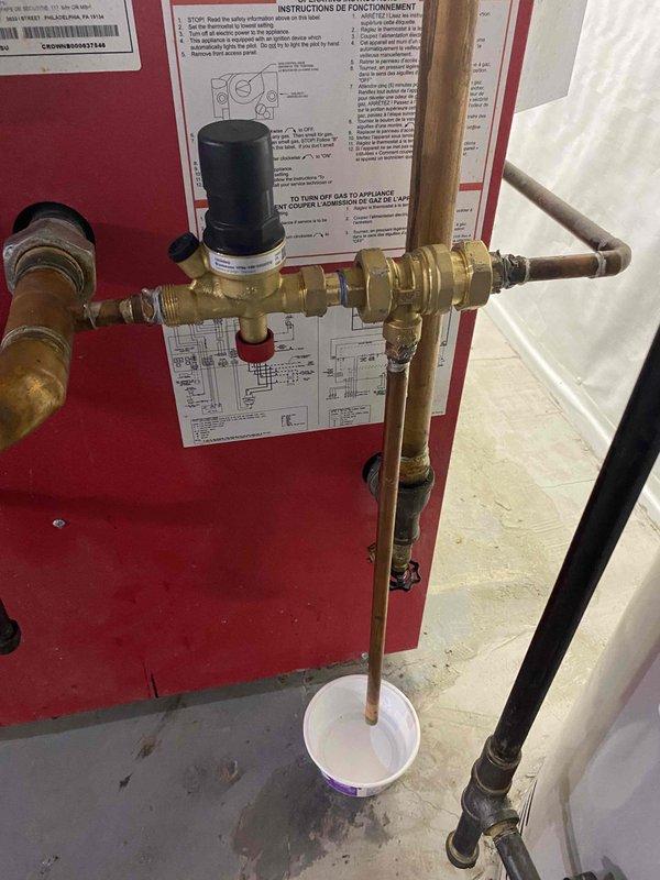 Returned to property to complete installation of pressure reducing valve (PRV) that was previously sold. Installed brass PRV assembly on main water supply line with appropriate compression fittings and connections. Mounted unit on existing red panel near water treatment system. Verified proper orientation and secure mounting of pressure regulator. Connected inlet and outlet piping using brass fittings to ensure leak-free operation. Tested system operation and confirmed pressure regulation functioning correctly. Left installation instructions posted on panel for reference.