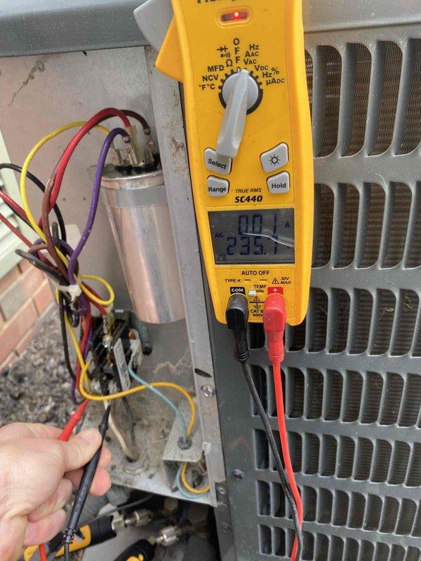 Completed prepaid cooling maintenance on outdoor air conditioning unit. Performed comprehensive electrical diagnostics using digital multimeter, measuring voltage readings at capacitor and electrical components to verify proper system operation. Capacitor tested at 23.5 volts with all wire connections secure. Conducted amperage measurement on brown wire using clamp meter, recording 0.63 amps, which falls within normal operating parameters. All electrical connections, including red, yellow, purple, and black wires, inspected and found properly secured with appropriate wire management. Condenser coil and unit exterior show normal weathering with minor dirt accumulation consistent with outdoor installation. System operating within manufacturer specifications with no deficiencies noted.