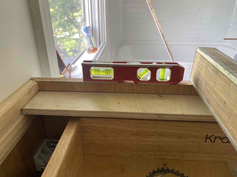 Returned to complete final plumbing installation on active construction project. Completed rough-in connections including copper supply line routing to bathroom vanity location, verified proper drainage assembly installation in vanity cabinet drawer base, and ensured all plumbing components were level and properly aligned with stair construction work in progress.