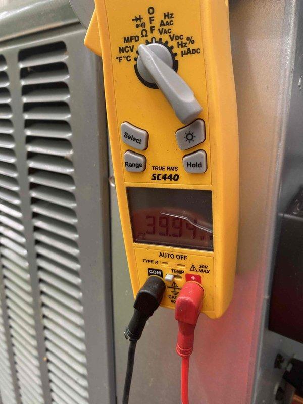 Completed cooling maintenance on air handler unit as part of club membership service. Performed diagnostic testing using digital multimeter, recording voltage reading of 335V and temperature measurement of 119°F to verify system operation and component performance. Inspected HVAC equipment including ventilation components and documented conditions through photos for service records.