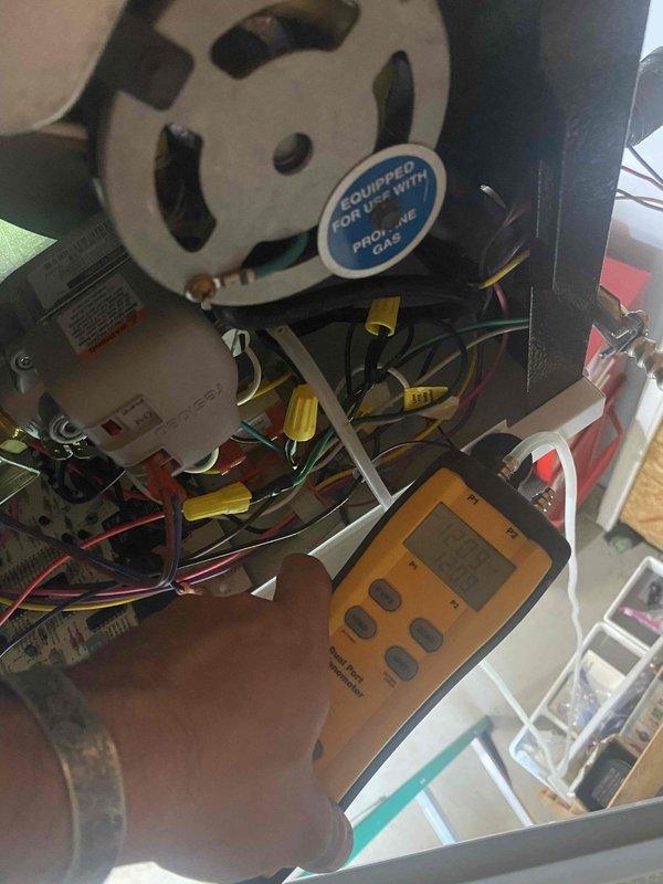 Returned to complete propane gas regulator installation following material arrival. Performed diagnostic testing using digital manometer to verify gas pressure readings at 1865 on both P1 and P2 channels, ensuring proper system operation. Accessed HVAC equipment internal components to complete electrical connections and wiring integration for the new regulator. Verified all wire terminations and tested system functionality to confirm safe operation of the propane gas supply system.