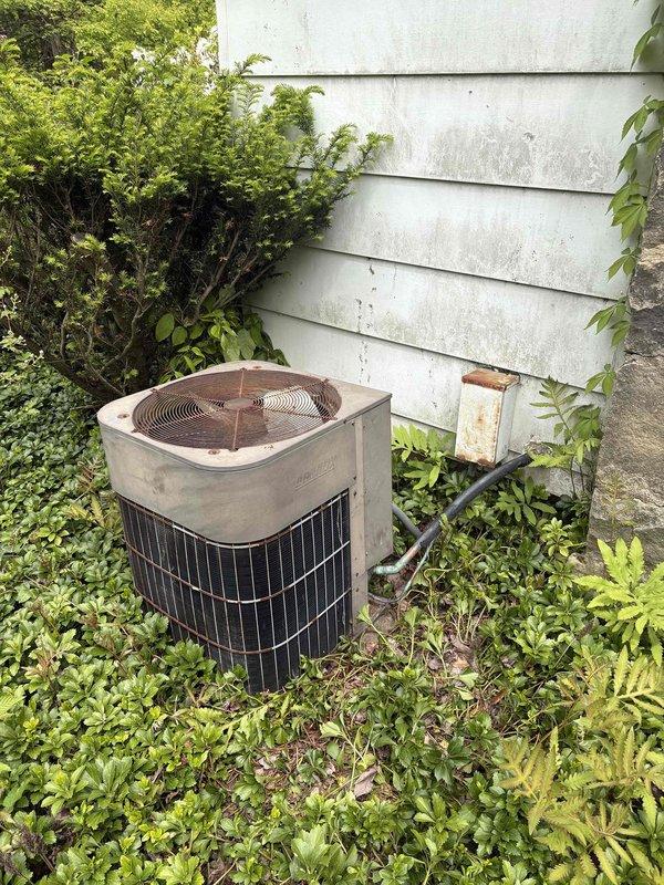 Completed estimate for replacement of 38-year-old residential air conditioning system that has reached end of serviceable life. Assessed existing outdoor condensing unit showing significant age-related deterioration, weathering, and vegetation encroachment requiring clearance for proper airflow. Evaluated electrical service including dedicated 30-amp breaker circuit and documented current system configuration to determine appropriate replacement specifications.