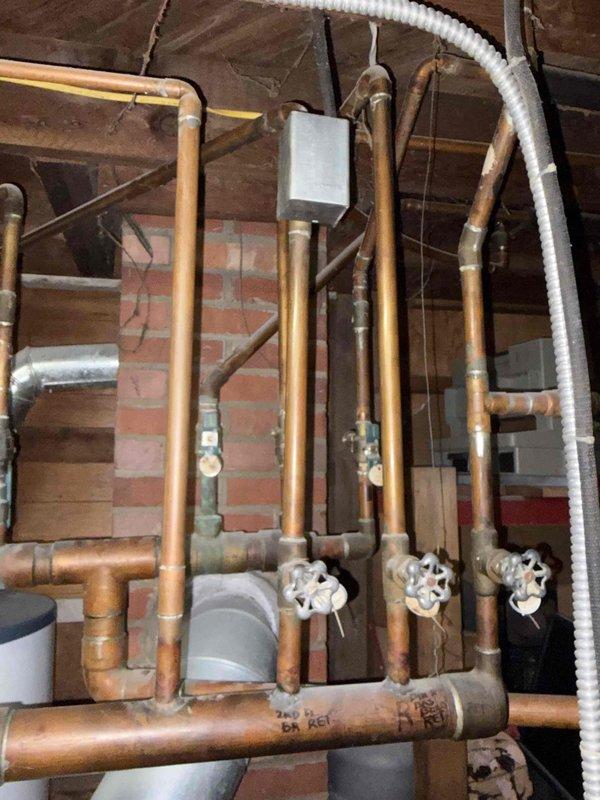 Responded to no heat complaint affecting upstairs zones on aging boiler system. Inspected multi-zone hydronic heating system including boiler, circulator pumps, zone valves, and distribution piping throughout basement utility area. Identified malfunctioning zone valve preventing hot water circulation to upper floor heating loop. Verified boiler operation and primary loop functionality, confirmed proper water temperature and pressure levels. Cycled zone valves and tested electrical connections to isolate failed component affecting upstairs heat delivery.