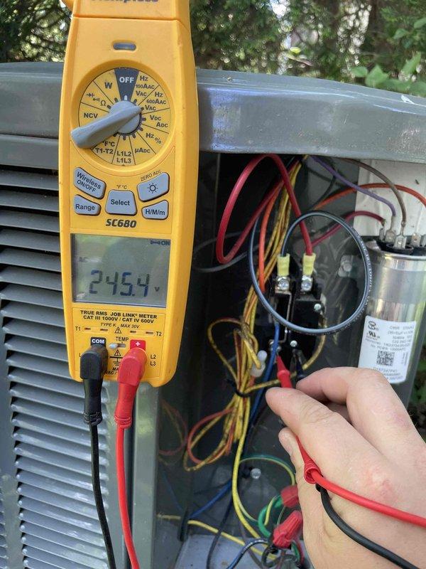 Completed cooling maintenance club visit on air handler system. Performed comprehensive electrical diagnostics using digital multimeter, recording voltage readings of 245V at main power supply and 4.992V at control circuit. Tested capacitor, contactor, and all electrical connections within outdoor unit compartment to verify proper system operation and component functionality.
