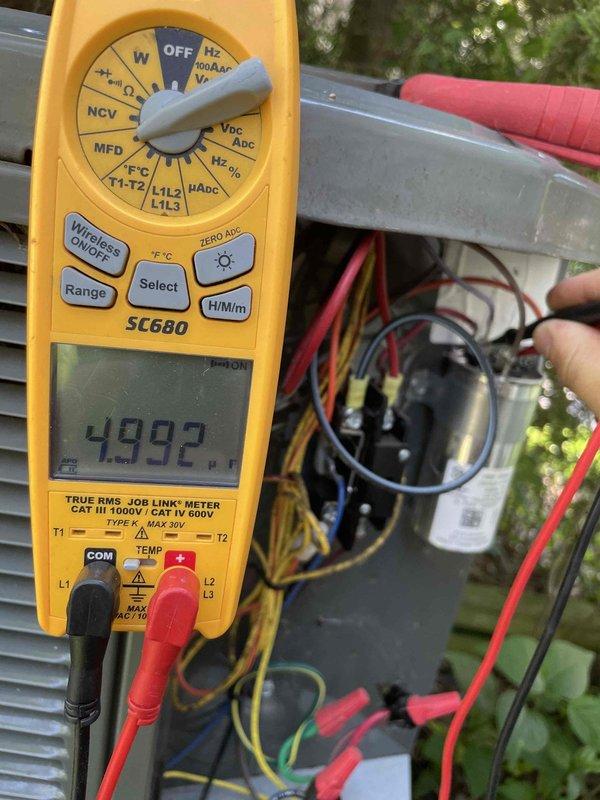 Completed cooling maintenance club visit on air handler system. Performed comprehensive electrical diagnostics using digital multimeter, recording voltage readings of 245V at main power supply and 4.992V at control circuit. Tested capacitor, contactor, and all electrical connections within outdoor unit compartment to verify proper system operation and component functionality.
