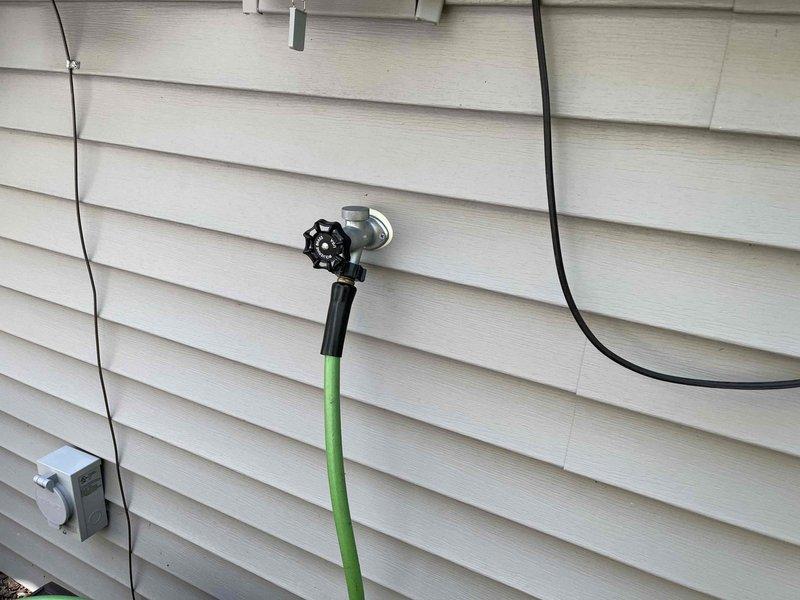Completed plumbing membership inspection at residential property. Inspected exterior hose bib and connection on building exterior, verifying proper operation and checking for leaks or damage to the fixture and surrounding components. Examined under-sink plumbing system in kitchen, including dual basin drain configuration with P-trap assemblies and all connecting pipes, confirming proper drainage function and absence of leaks.