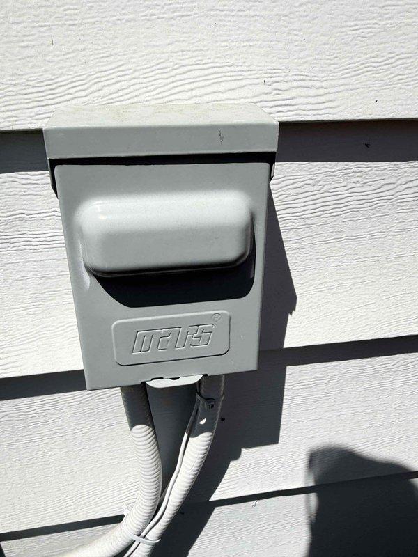 Completed comprehensive air conditioning tune-up service on residential system. Performed electrical diagnostics using digital multimeter to verify proper voltage and amperage readings at the outdoor condensing unit. Inspected exterior disconnect box and electrical connections, confirming secure mounting and proper conduit installation. System operating within normal parameters with no deficiencies identified during inspection.