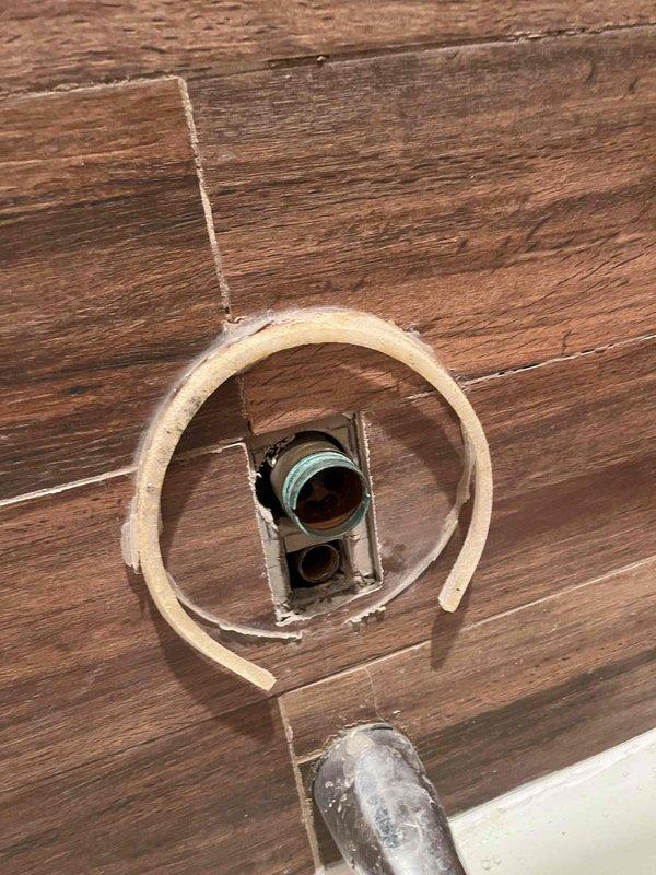 Returned to property to address shower cartridge replacement that was previously sold. Upon inspection, removed severely corroded Delta valve assembly from shower, which exhibited extensive rust buildup, deteriorated chrome finish, and compromised threaded connections. The corrosion had caused visible staining in the bathtub area. Accessed plumbing through existing floor access point with foam insulation ring and verified cartridge compatibility. Documented existing conditions and confirmed Delta replacement parts availability for installation upon verification of exact model specifications.