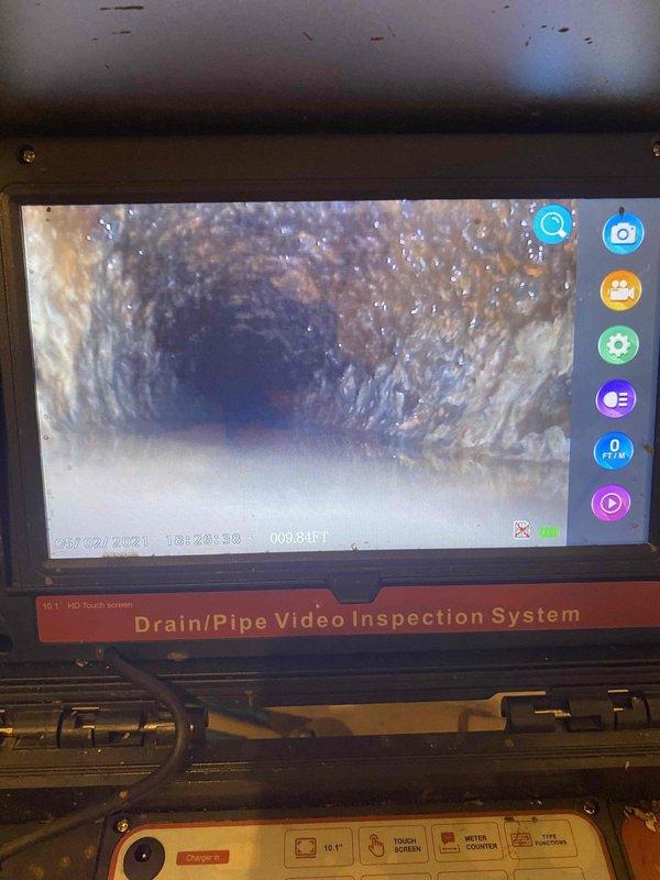 Returned to property to complete previously sold toilet removal and sewer line jetting service. Successfully pulled toilet from flange to access main drain line. Deployed professional drain/pipe video inspection system to assess sewer line condition prior to jetting, confirming presence of debris accumulation and sediment buildup along pipe walls. Performed high-pressure hydro-jetting of main sewer line to clear blockages and restore proper drainage flow. Video inspection documented interior pipe condition showing typical residue and material buildup requiring mechanical cleaning intervention.