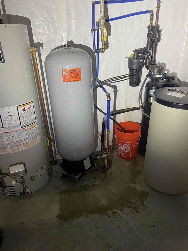 Installed new FL12 pressure tank in mechanical room to replace failed unit. Connected tank to existing plumbing system using blue PEX tubing and appropriate fittings, ensuring proper integration with water heater and expansion tank. Tested system pressure and verified proper operation of all components upon completion.