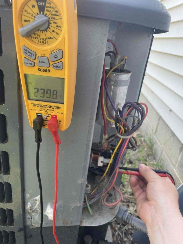 Responded to no cooling complaint on 6-year-old residential air conditioning system. Upon arrival, performed electrical diagnostics at outdoor condensing unit using digital multimeter. Testing revealed capacitor failure with abnormal readings of 2398 on meter display. Removed and replaced defective dual-run capacitor (CBB65B rated 50/5 MFD) with new unit. Verified proper electrical connections, confirmed system operation, and restored cooling functionality. Unit returned to normal operating parameters.