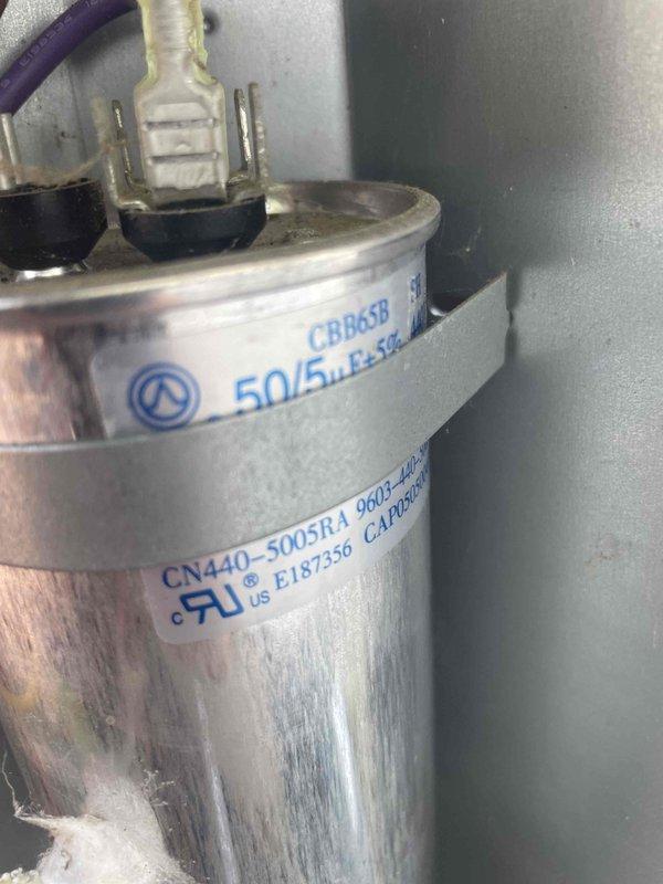 Responded to no cooling complaint on 6-year-old residential air conditioning system. Upon arrival, performed electrical diagnostics at outdoor condensing unit using digital multimeter. Testing revealed capacitor failure with abnormal readings of 2398 on meter display. Removed and replaced defective dual-run capacitor (CBB65B rated 50/5 MFD) with new unit. Verified proper electrical connections, confirmed system operation, and restored cooling functionality. Unit returned to normal operating parameters.