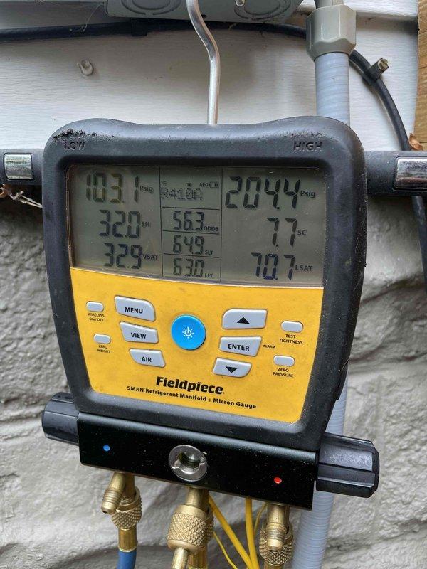 Completed scheduled cooling maintenance member visit on residential HVAC system. Performed comprehensive system diagnostics using Fieldpiece SMAN refrigerant manifold gauge, recording operating pressures of 103.7 psig on low side and 204.4 psig on high side with temperatures reading 320°F and 323°F. Verified proper refrigerant charge and system performance parameters within manufacturer specifications. Removed access panel to inspect interior electrical components, capacitor, and contactor assembly. All wiring connections found secure with no signs of overheating or degradation. Capacitor tested and functioning properly with secure mounting bracket. Verified all safety labels and warning decals present and legible. System operating efficiently with no deficiencies noted.