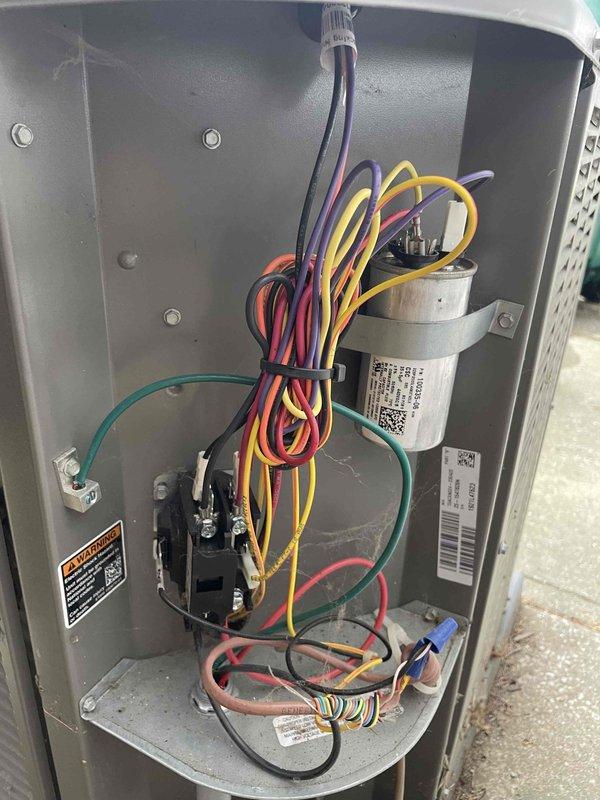 Completed scheduled cooling maintenance member visit on residential HVAC system. Performed comprehensive system diagnostics using Fieldpiece SMAN refrigerant manifold gauge, recording operating pressures of 103.7 psig on low side and 204.4 psig on high side with temperatures reading 320°F and 323°F. Verified proper refrigerant charge and system performance parameters within manufacturer specifications. Removed access panel to inspect interior electrical components, capacitor, and contactor assembly. All wiring connections found secure with no signs of overheating or degradation. Capacitor tested and functioning properly with secure mounting bracket. Verified all safety labels and warning decals present and legible. System operating efficiently with no deficiencies noted.