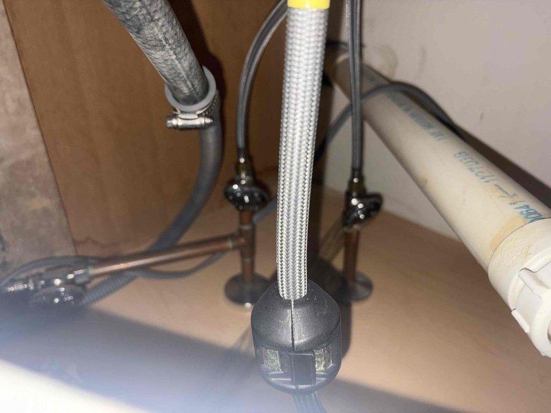 Responded to callback for leaking faucet issue. Upon arrival, inspected bathroom plumbing fixtures and water supply connections. Verified toilet water supply line installation with braided flex hose and shut-off valve connections were properly secured and functioning without leaks. Documented plumbing system configuration including wall-mounted tank connections and floor-mounted shut-off valve. All water supply lines and connections tested and confirmed operational.