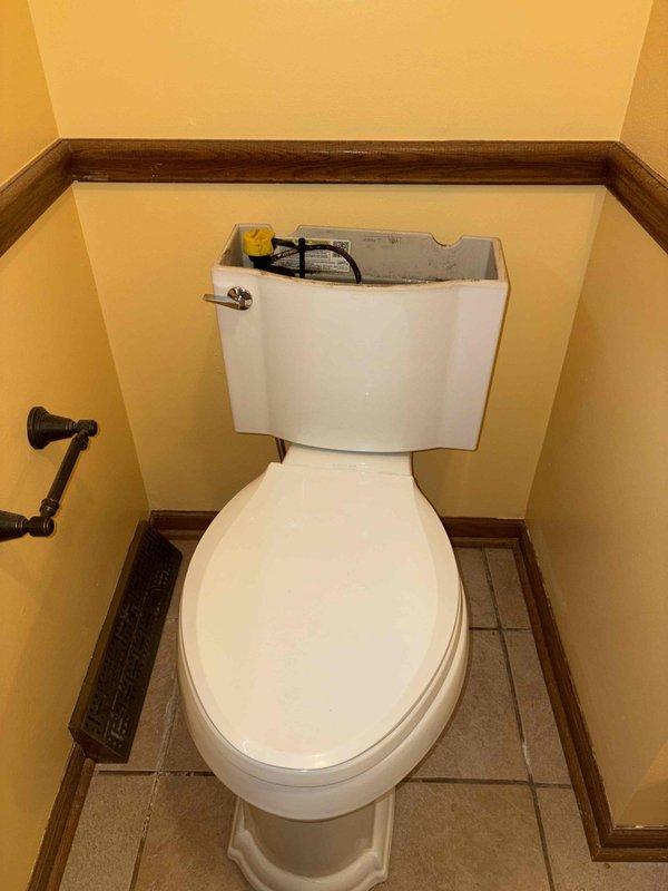 Responded to a service call for a leaking toilet with concerns about water damage to the ceiling below. Inspected the toilet tank components, including the fill valve, flush valve assembly, and flapper mechanism, and examined the toilet base and floor flange for signs of water infiltration. Documented the condition of the internal tank components and the wax ring seal area to determine the source of the leak and recommend appropriate repairs.