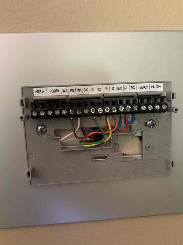 Responded to service call for American Standard thermostat displaying frozen logo screen. Upon arrival, found thermostat stuck on startup screen and unresponsive to user inputs. Removed thermostat from wall plate, inspected wiring connections at terminal block, and verified all wire terminations were secure at R, C, W, Y, and G terminals. Performed power cycle by disconnecting C wire for two minutes to allow system to fully reset. Reinstalled thermostat on wall plate, restored power, and observed successful boot sequence. Thermostat returned to normal operation, displaying current temperature of 68°F with system idle status and all functions responding properly to touch commands.