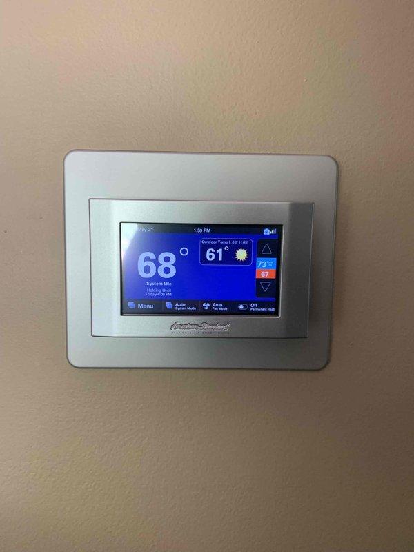 Responded to service call for American Standard thermostat displaying frozen logo screen. Upon arrival, found thermostat stuck on startup screen and unresponsive to user inputs. Removed thermostat from wall plate, inspected wiring connections at terminal block, and verified all wire terminations were secure at R, C, W, Y, and G terminals. Performed power cycle by disconnecting C wire for two minutes to allow system to fully reset. Reinstalled thermostat on wall plate, restored power, and observed successful boot sequence. Thermostat returned to normal operation, displaying current temperature of 68°F with system idle status and all functions responding properly to touch commands.