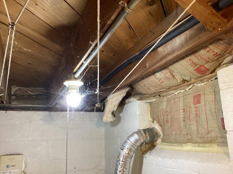 Conducted on-site evaluation of existing central air conditioning system to provide replacement estimate. Inspected current HVAC installation in basement utility area, including existing ductwork, Carrier-branded humidifier unit dated from 2015, and associated electrical components. Documented equipment condition and configuration through photographs to support comprehensive replacement quote for new central air system.