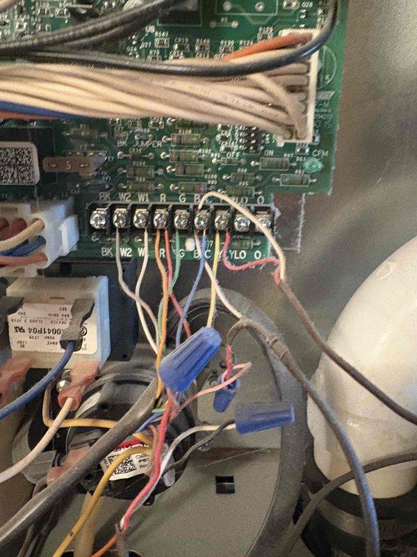 Responded to service call for air conditioning unit making strange noises and not operating. Upon inspection, determined system age and condition warranted full replacement rather than repair. Provided comprehensive estimate for complete HVAC system replacement, documenting existing equipment configuration including control board wiring, electrical connections, and mechanical components in confined crawlspace installation. Photographed current system setup showing multi-wire terminal connections, capacitor assembly, and existing infrastructure including PVC drainage, copper refrigerant lines, and flexible conduit to assist with replacement planning and equipment specifications.