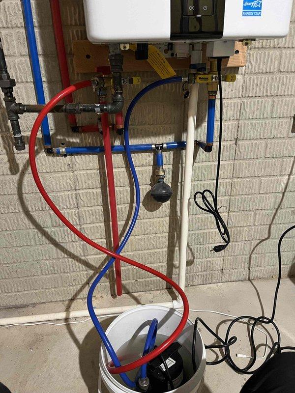 Performed comprehensive flush and descale service on tankless water heater unit. Connected service lines to isolation valves and circulated descaling solution through the heat exchanger to remove mineral buildup and sediment accumulation. Flushed system thoroughly until discharge water ran clear, restoring optimal heat transfer efficiency and flow rate performance.