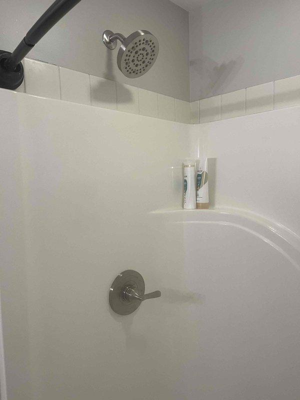 Responded to water leak complaint originating from shower fixture causing damage to basement below. Upon inspection, identified failed shower valve assembly as source of leak. Removed existing chrome shower valve and trim, then installed customer-provided replacement fixture. Tested new installation for proper operation and verified complete seal with no active leaks detected. Confirmed water flow to basement had been eliminated.