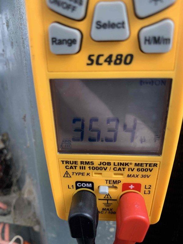 Responded to no cooling call on 15-year-old air conditioning system with outdoor fan not operating. Upon arrival, performed diagnostic testing and measured amperage draw at 35.34 amps using digital multimeter at the outdoor unit. Inspected electrical disconnect box mounted on exterior wall, which showed significant age-related deterioration including accumulated debris, spider webs, and weathered components. Verified power supply to condensing unit and tested electrical connections at disconnect switch. Based on equipment age, component condition, and diagnostic findings, identified failed outdoor fan motor as primary cause of no cooling condition. Provided customer with repair options and recommendations for aging system requiring immediate attention to restore cooling operation.