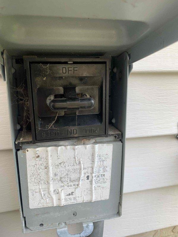 Responded to no cooling call on 15-year-old air conditioning system with outdoor fan not operating. Upon arrival, performed diagnostic testing and measured amperage draw at 35.34 amps using digital multimeter at the outdoor unit. Inspected electrical disconnect box mounted on exterior wall, which showed significant age-related deterioration including accumulated debris, spider webs, and weathered components. Verified power supply to condensing unit and tested electrical connections at disconnect switch. Based on equipment age, component condition, and diagnostic findings, identified failed outdoor fan motor as primary cause of no cooling condition. Provided customer with repair options and recommendations for aging system requiring immediate attention to restore cooling operation.