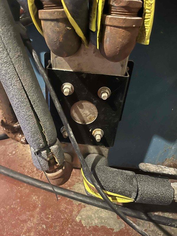 Evaluated existing oil-fired boiler system with supplementary wood fire boiler for potential conversion to propane fuel. Documented current installation including corroded electrical terminals and connections, mechanical components, and associated plumbing infrastructure in basement mechanical room to provide comprehensive estimate for fuel conversion project.