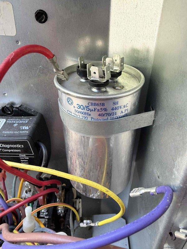 Responded to no cooling call on 2019 HVAC system where outdoor unit was buzzing but condenser fan not operating after breaker trip. Diagnosed failed dual run capacitor (30/5 MFD, 440VAC) preventing fan motor operation. Replaced defective capacitor, verified proper fan operation and compressor start-up, and confirmed system cooling normally with all electrical connections secure.