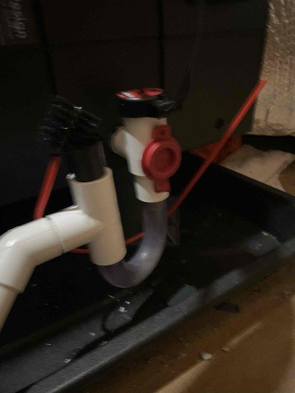 # HVAC Service Call - No Cooling Complaint

Responded to no cooling complaint on one-year-old HVAC system with recurring issues. Upon arrival, conducted diagnostic assessment of air conditioning system and associated components.

Inspection revealed condensate drainage system concerns. Examined PVC condensate drain line assembly with P-trap configuration and ball valve shut-off mechanism. Verified proper trap installation and drainage flow to prevent system shutdown due to float switch activation.

Investigated attic installation area where air handler is located. Reviewed system wiring diagram and verified electrical connections. Inspected humidifier component (AprilAir unit) for proper integration with HVAC system. Checked flexible conduit routing and low-voltage wiring connections for secure terminations and proper installation.

Performed standard diagnostic procedures including thermostat communication verification, refrigerant charge assessment, and safety control operation testi