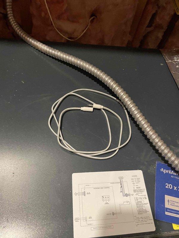 # HVAC Service Call - No Cooling Complaint

Responded to no cooling complaint on one-year-old HVAC system with recurring issues. Upon arrival, conducted diagnostic assessment of air conditioning system and associated components.

Inspection revealed condensate drainage system concerns. Examined PVC condensate drain line assembly with P-trap configuration and ball valve shut-off mechanism. Verified proper trap installation and drainage flow to prevent system shutdown due to float switch activation.

Investigated attic installation area where air handler is located. Reviewed system wiring diagram and verified electrical connections. Inspected humidifier component (AprilAir unit) for proper integration with HVAC system. Checked flexible conduit routing and low-voltage wiring connections for secure terminations and proper installation.

Performed standard diagnostic procedures including thermostat communication verification, refrigerant charge assessment, and safety control operation testi
