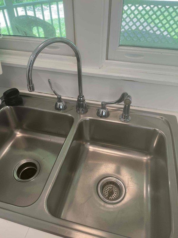 Responded to service call for low hot water flow at kitchen faucet. Upon inspection, found reduced hot water pressure affecting faucet performance. Examined water heater installation and supply line connections to diagnose flow restriction. Identified issue with hot water supply affecting delivery to the double-basin kitchen sink fixture. Performed necessary adjustments to restore proper hot water flow and pressure to the faucet assembly. Verified both hot and cold water lines functioning correctly at completion. System tested and confirmed adequate flow restored to kitchen faucet.